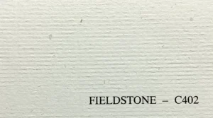 Close-up texture of Fieldstone C402 65 lb cover paper showing natural inclusions and ribbed finish.