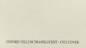 Sheets of Oxford Vellum Translucent C932 cover stock on a desk.
