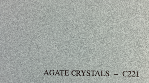 Gray textured surface resembling stone with fine, grainy details. Black text at the bottom reads "AGATE CRYSTALS – C221." The tone is neutral and earthy.
